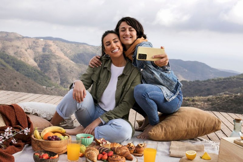 full-shot-smiley-women-taking-selfie-outdoors_23-2149333796